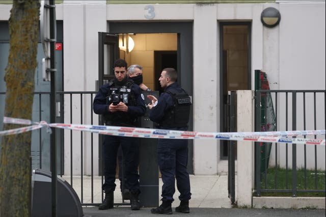 <p>French police stand in front of a building where five bodies were found dead in Meaux</p>