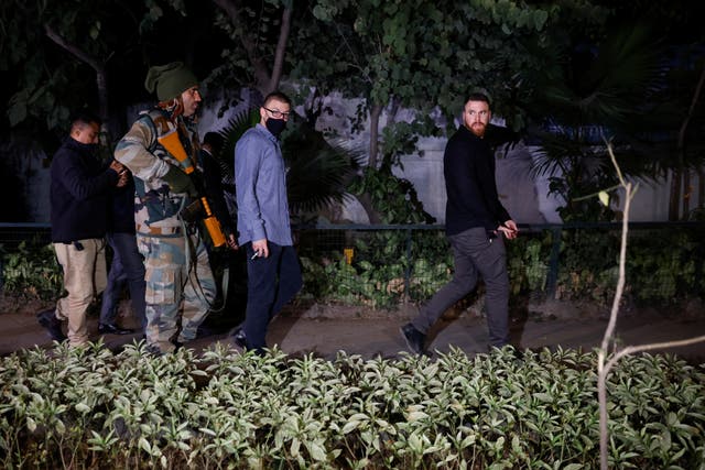 <p>Israel embassy officials and members of the security forces check the area, following a reported explosion nearby, in New Delhi, India</p>