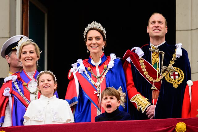 Prince Louis entertains his sister Princess Charlotte on the Palace balcony (Leon Neal/PA)