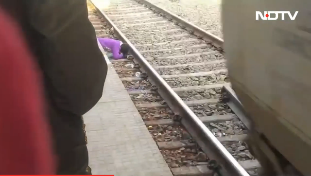 <p>A mother in India saves her two children from a train in India  </p>