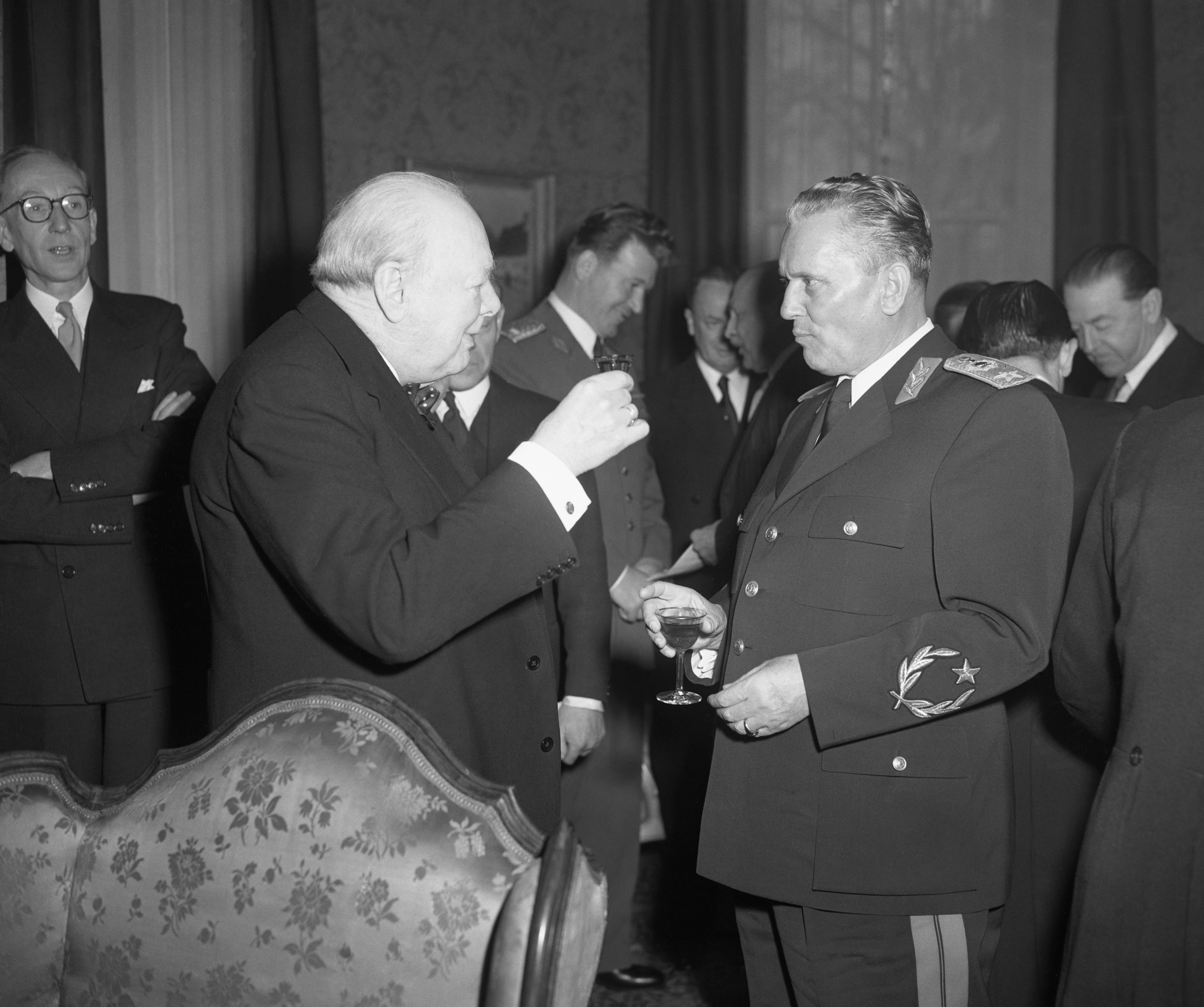 Winston Churchill raises a glass to toast Marshal Tito at the Yugoslav embassy in Kensington 1953