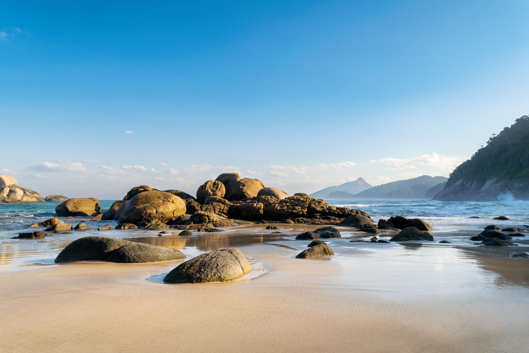 Lively corals teeming with marine life lap the powder sands on Lopes Mendes