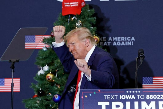 Former US President and 2024 presidential hopeful Donald Trump gestures during a campaign event in Waterloo, Iowa, on December 19, 2023