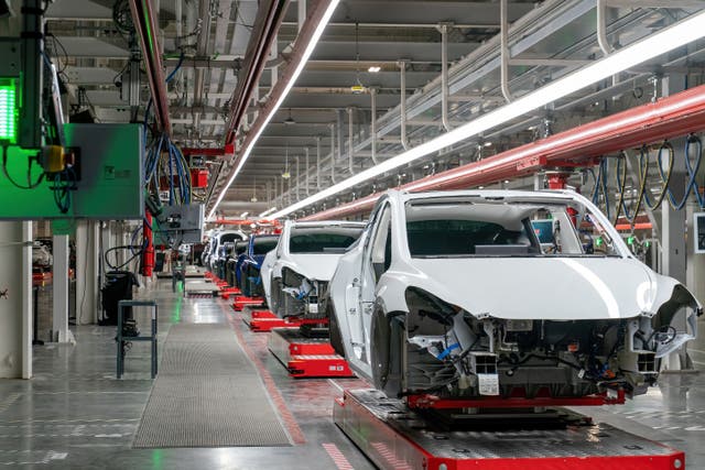 <p>Cars are seen on the assembly line during a tour of the Tesla Giga Texas manufacturing facility ahead of the "Cyber Rodeo" grand opening party on April 7, 2022 in Austin</p>