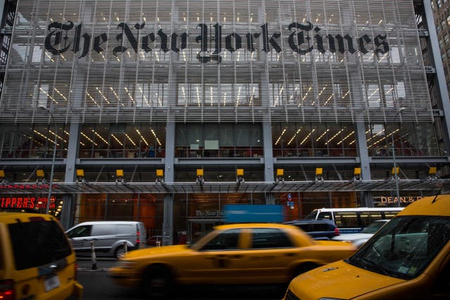 <p>Traffic drives past The New York Times building in October 2014 in New York City</p>