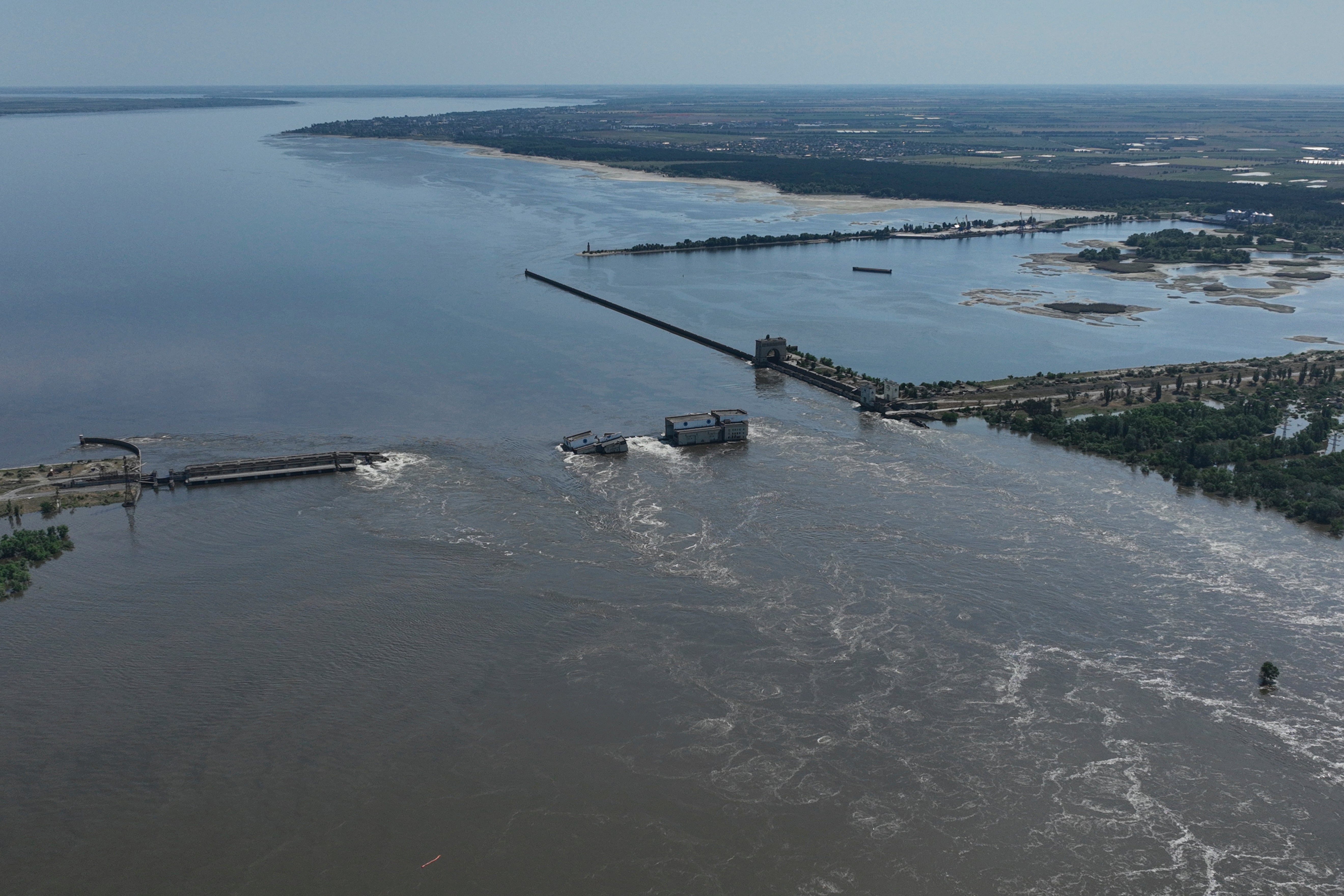 Water flows over the collapsed Kakhovka -Dam