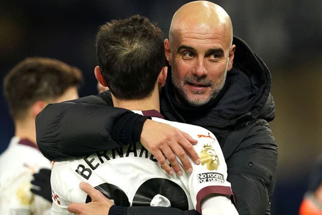 Manchester City manager Pep Guardiola hugs Bernardo Silva after the 3-1 comeback win at Everton (Martin Rickett/PA).