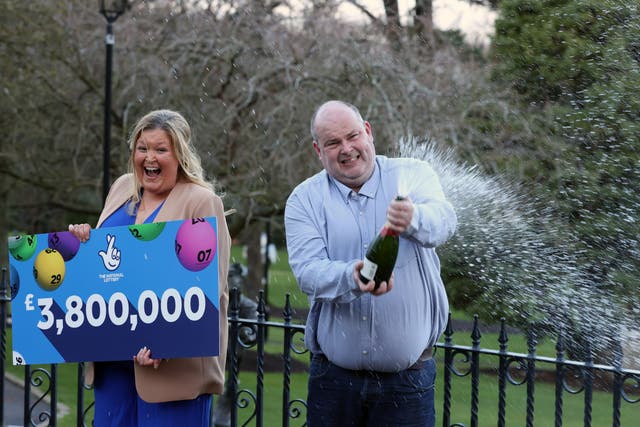 <p>Jonny Johnston and his partner Christina Williams from County Fermanagh, celebrate at the Culloden Estate & Spa Hotel in Belfast, after winning £3.8m in the Lotto </p>