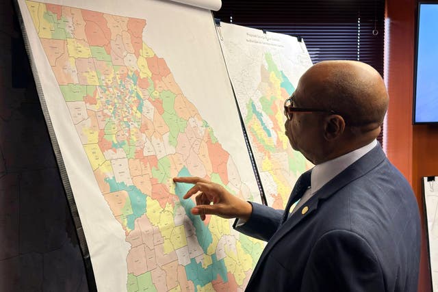 <p>Georgia Rep Mack Jackson looks at a map of proposed state House districts on 29 November. </p>