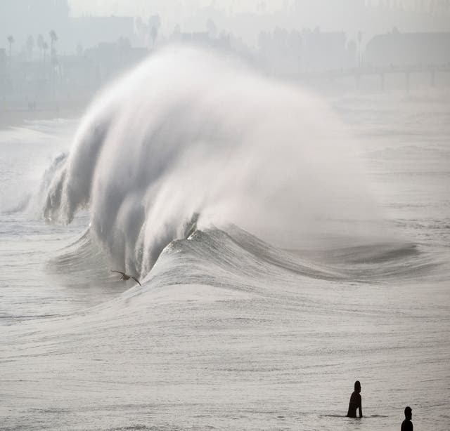 Huge surf pounds beaches on West Coast and in Hawaii with some low-lying  coastal areas flooding