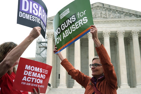 Activists hold up signs outside US Supreme Court during a gun-control rally on 7 November 2023 in Washington, DC.
