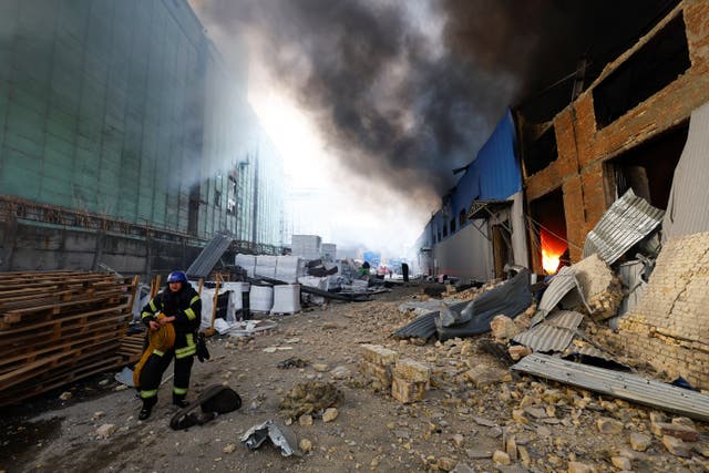<p>A firefighter works at a site of a warehouse heavily damaged during a Russian missile strike</p>
