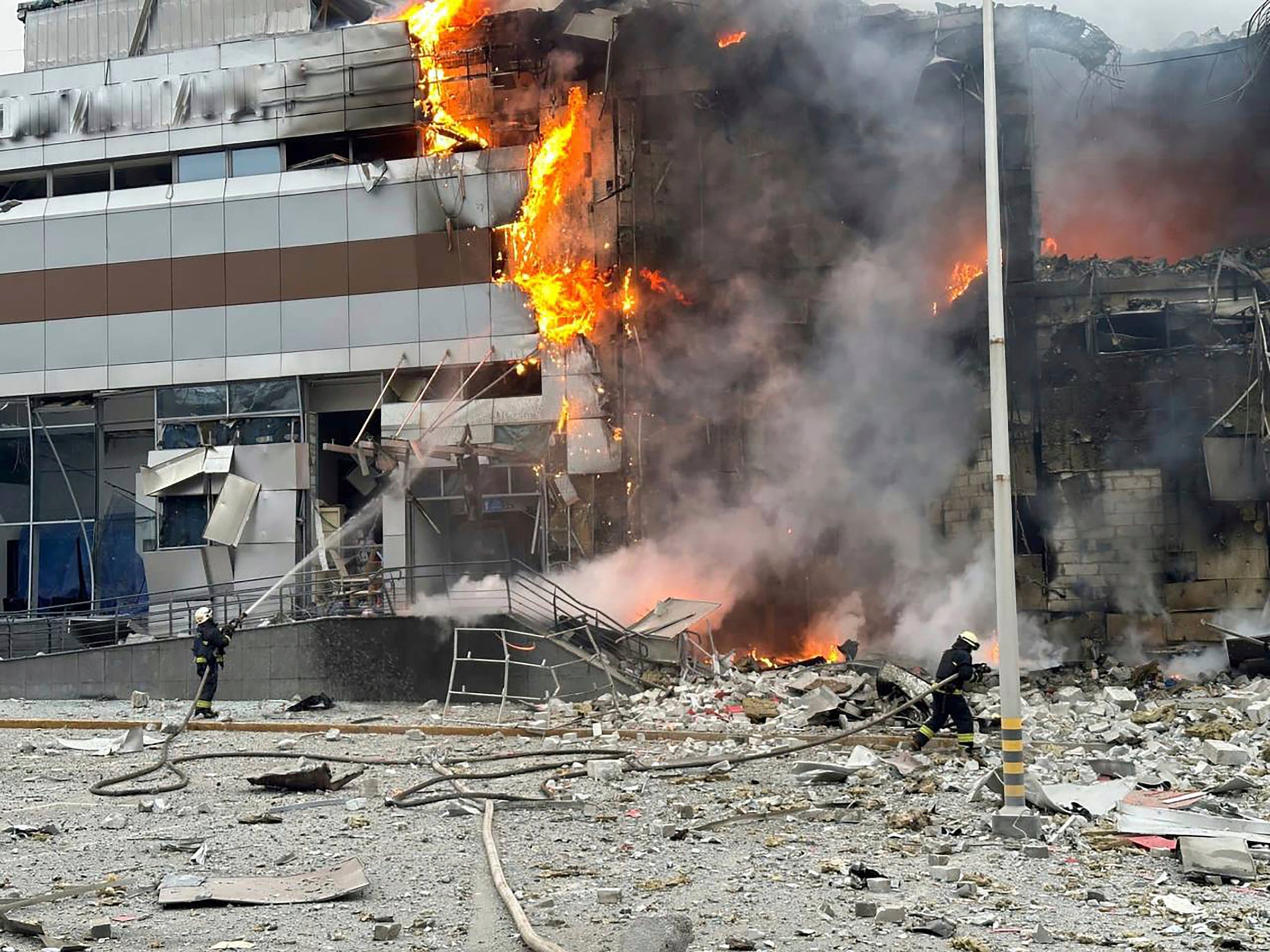Firefighters work on a site of a building damaged after a Russian attack in Kyiv, Ukraine