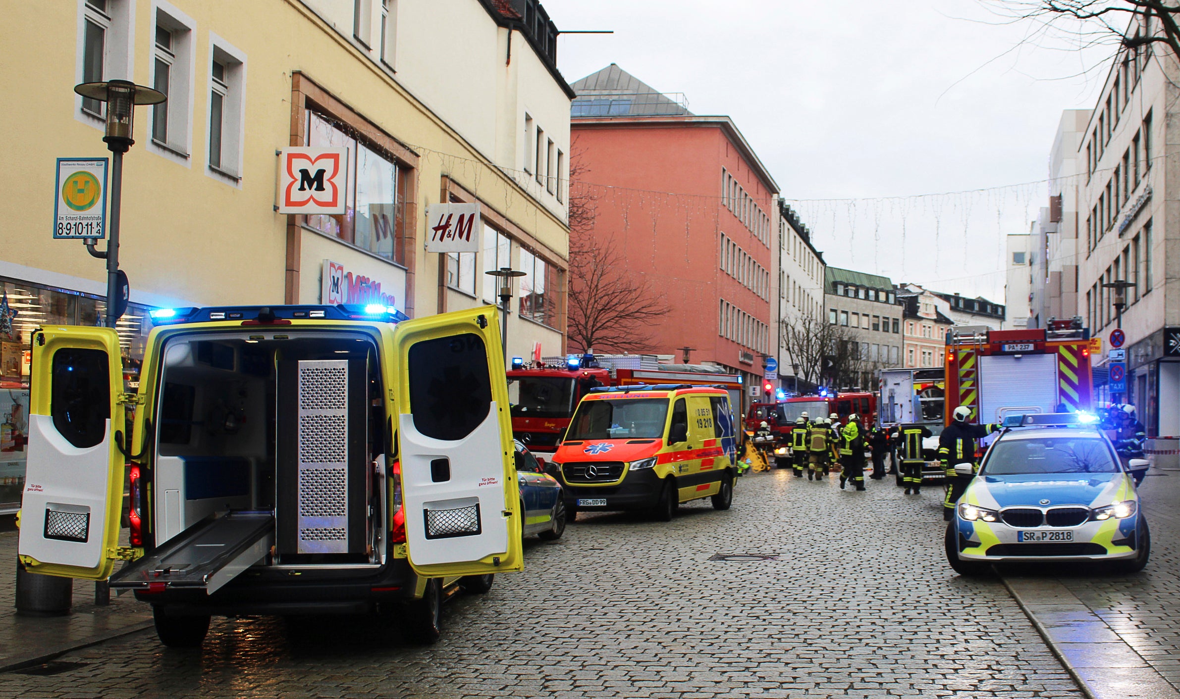 Emergency services from the police, fire department and ambulance stand at the scene of an accident in the city center in Passau, Germany