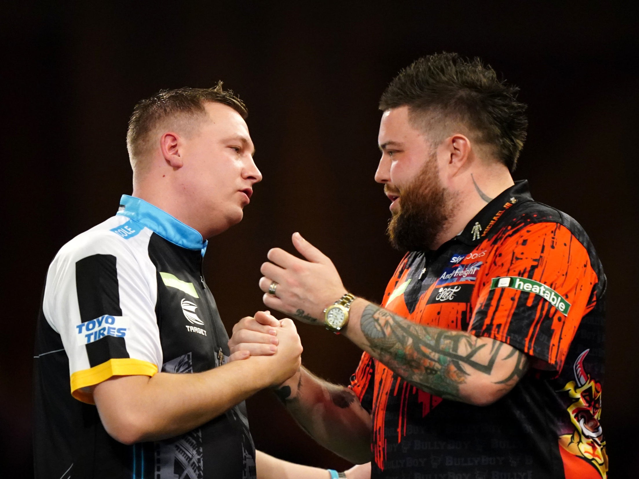 Chris Dobey embraces Michael Smith after defeating the 2023 champion