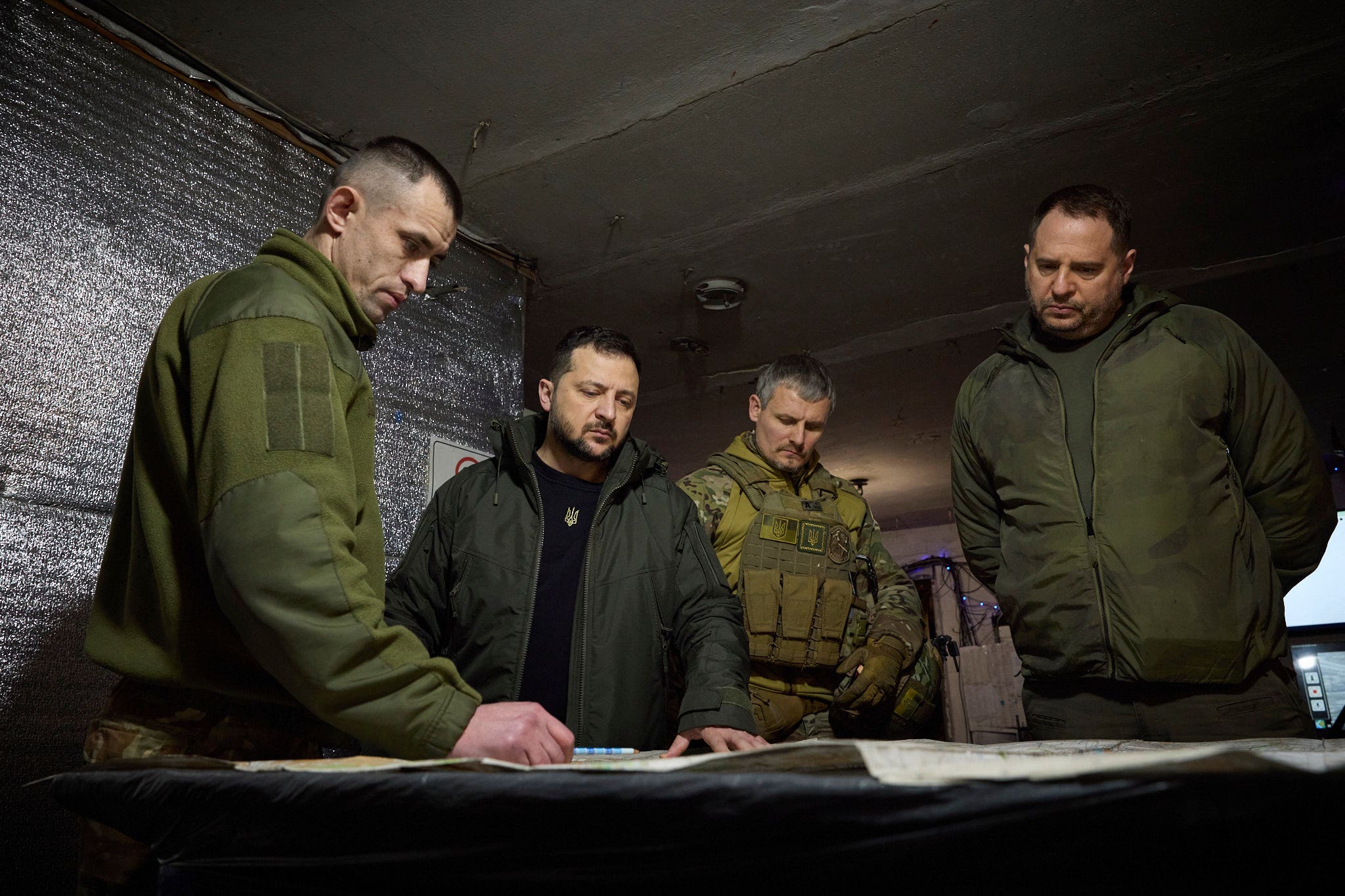 Ukrainian President Volodymyr Zelensky, second left, looks at a map during his visit to the Ukrainian 110th mechanised brigade in Avdiivka, the site of fierce battles with the Russian troops in the Donetsk region (Ukrainian Presidential Press Council/PA)