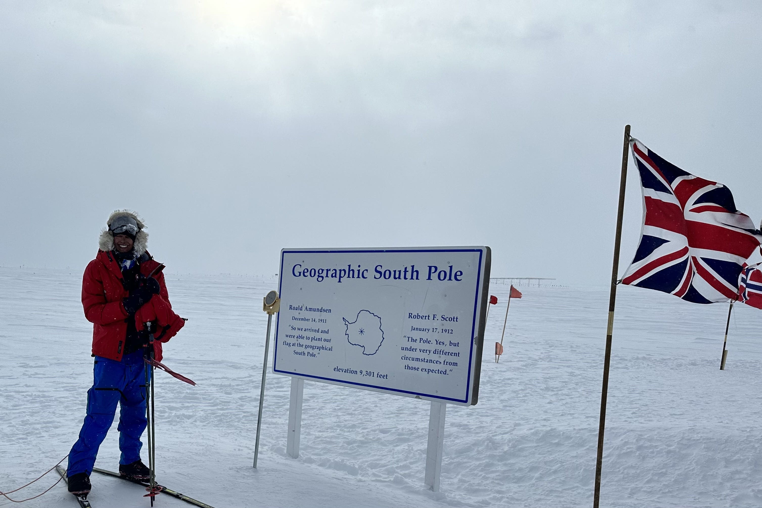 Chandi, from Derby, posing beside the signpost at the end of her solo unsupported south pole ski expedition