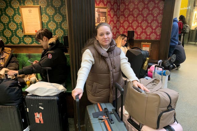 Tourist Nicole Carrera, 29, who is visiting the UK from New York with her husband Christopher, waits at St Pancras International station (Lucas Cumiskey/PA)