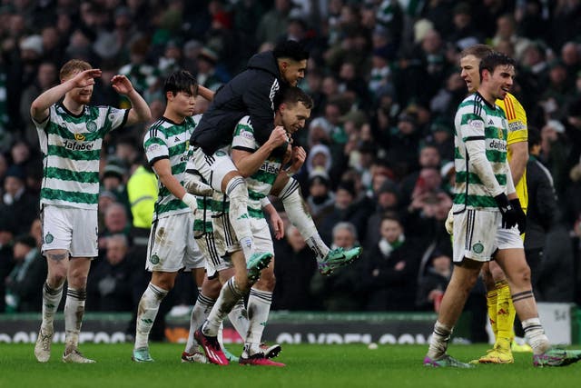 <p>Celtic players celebrate after their Old Firm victory </p>