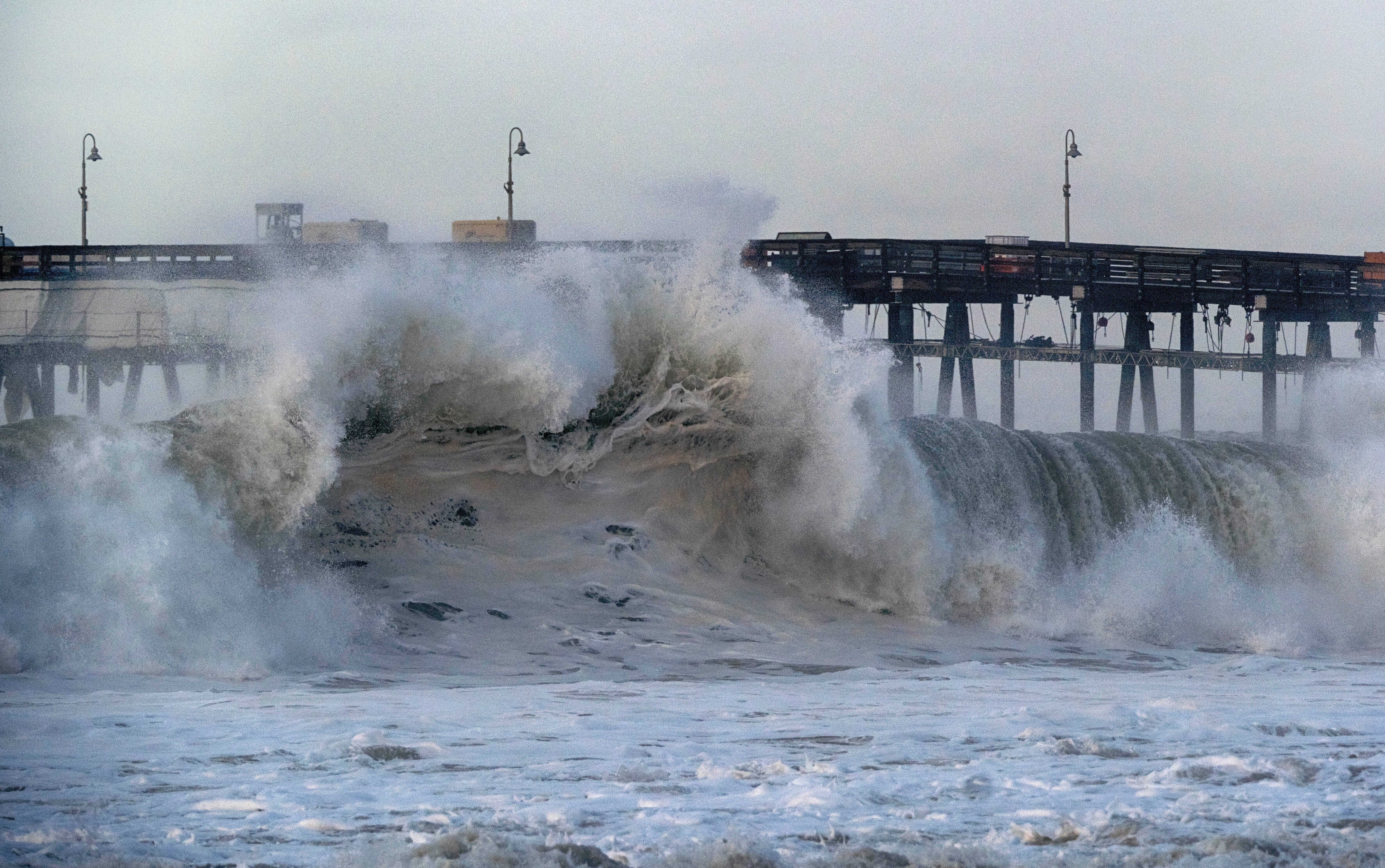 A very large wave breaks near the Ventura pier on Saturday 30 December 2023 in Ventura, Calif.