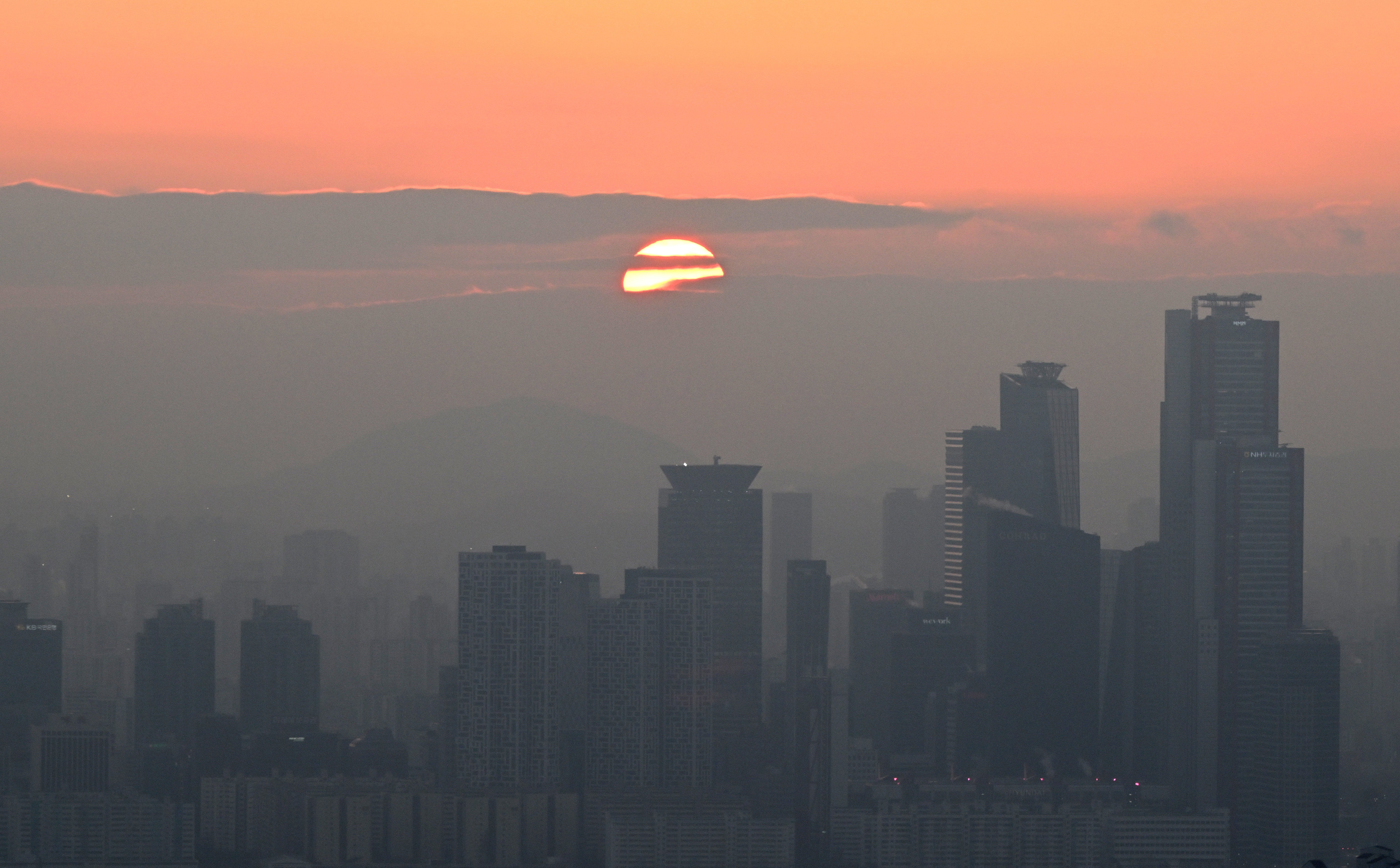 A general view shows the last sunset of the year in Seoul