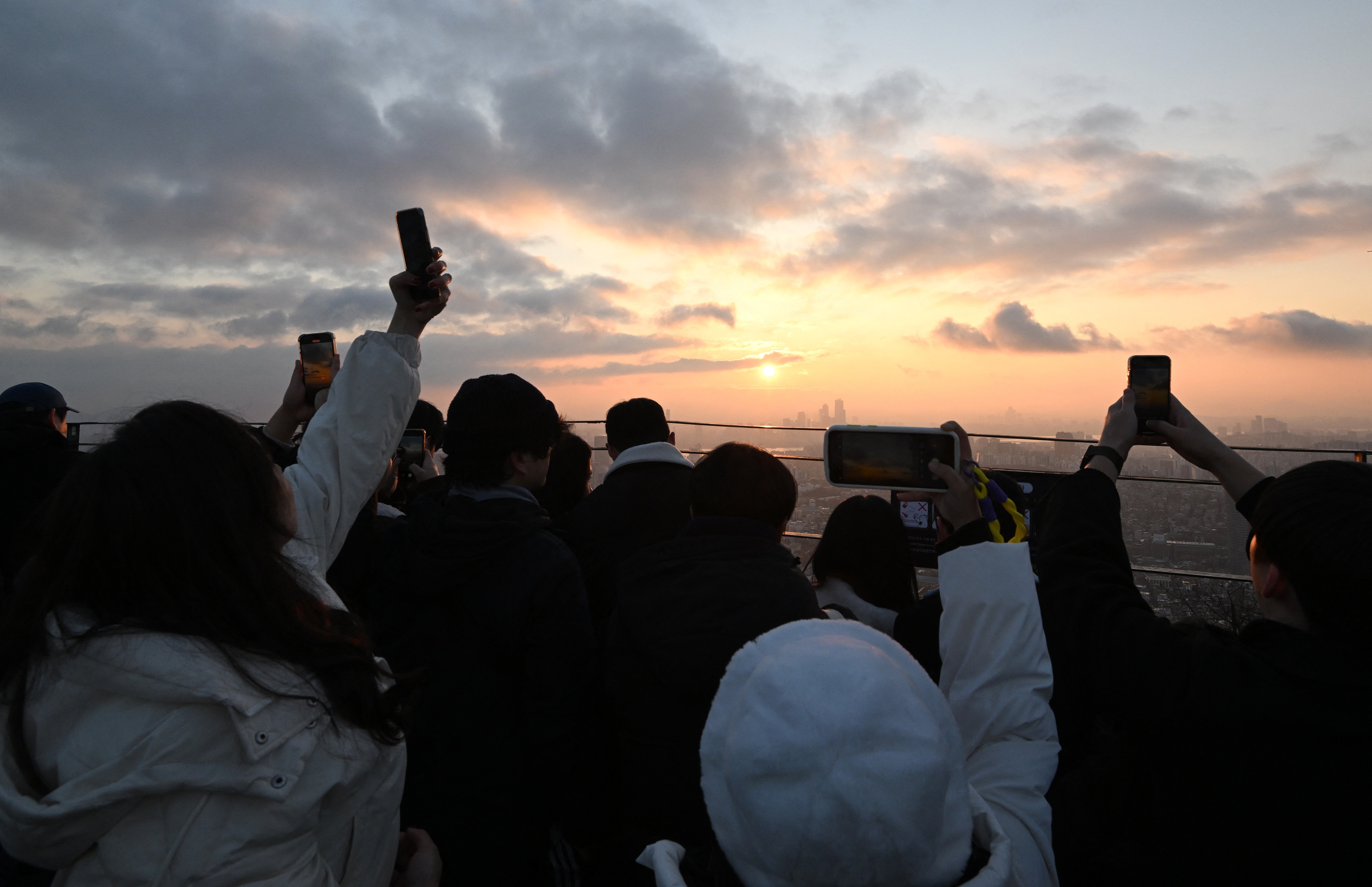 <p>Thousands gather to admire the final sunset in South Korea </p>