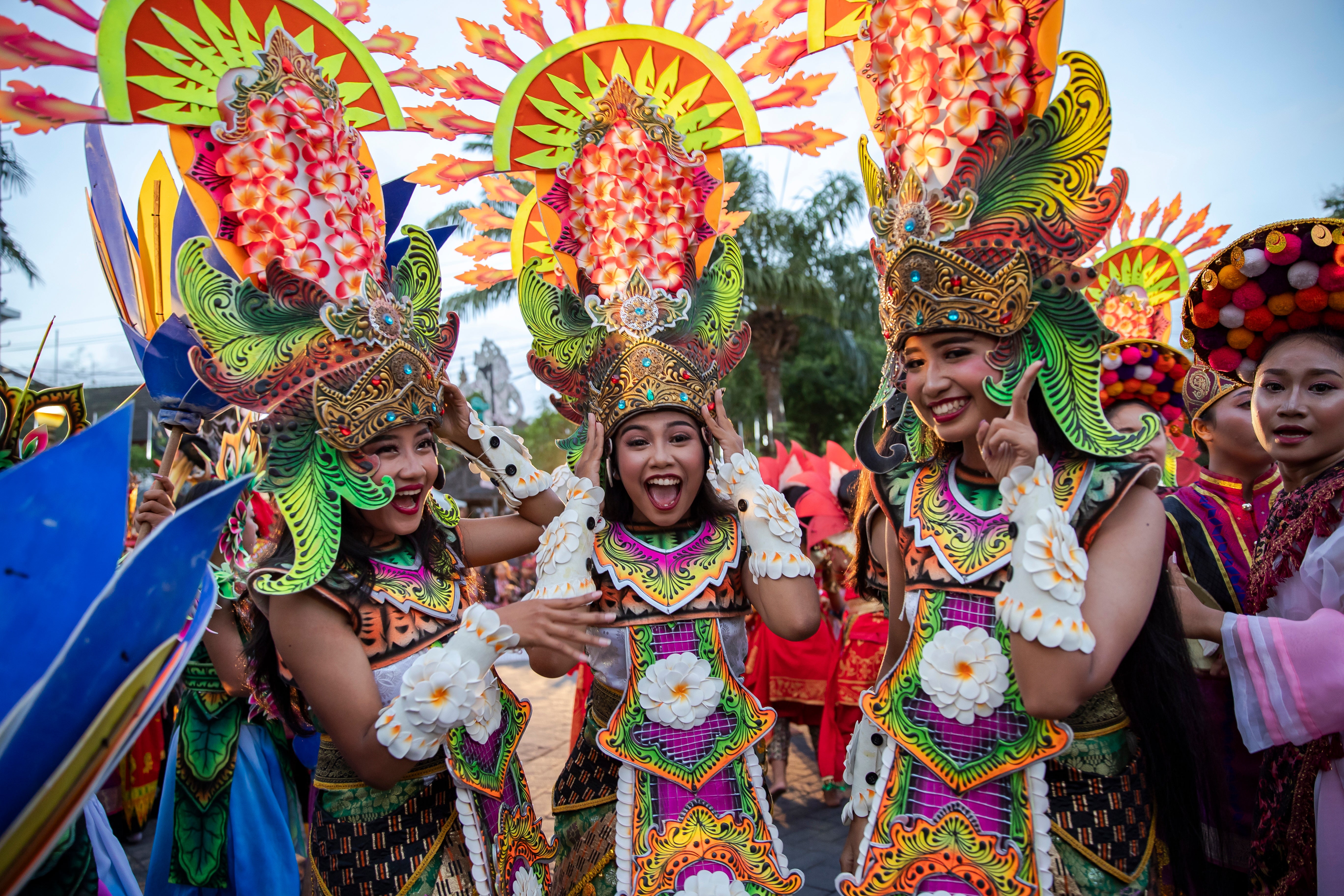 Balinese dancers perform as they take part in a cultural parade, during a new year's eve celebration at a main road in Denpasar, Bali