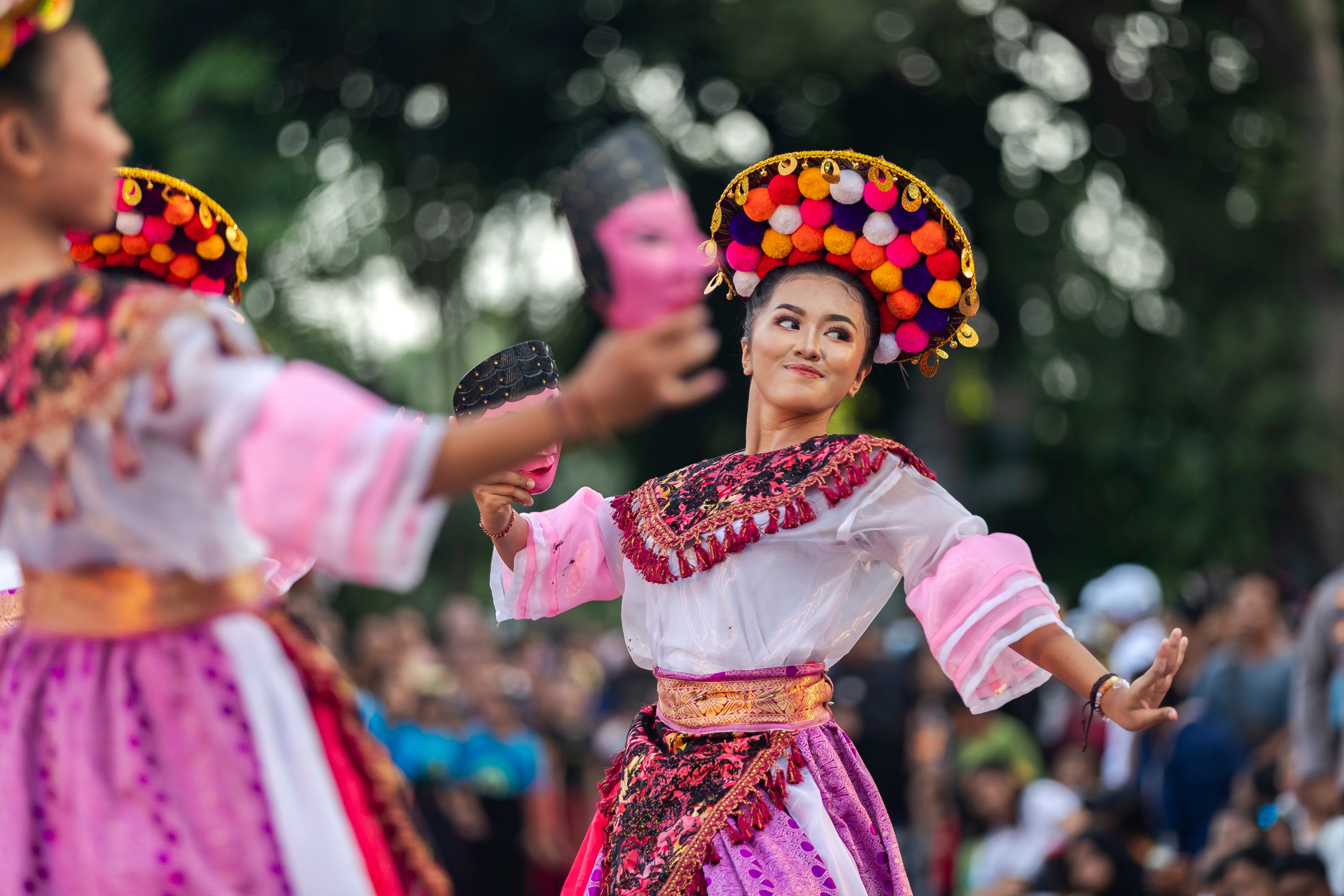 Performers participate in a cultural parade in Bali