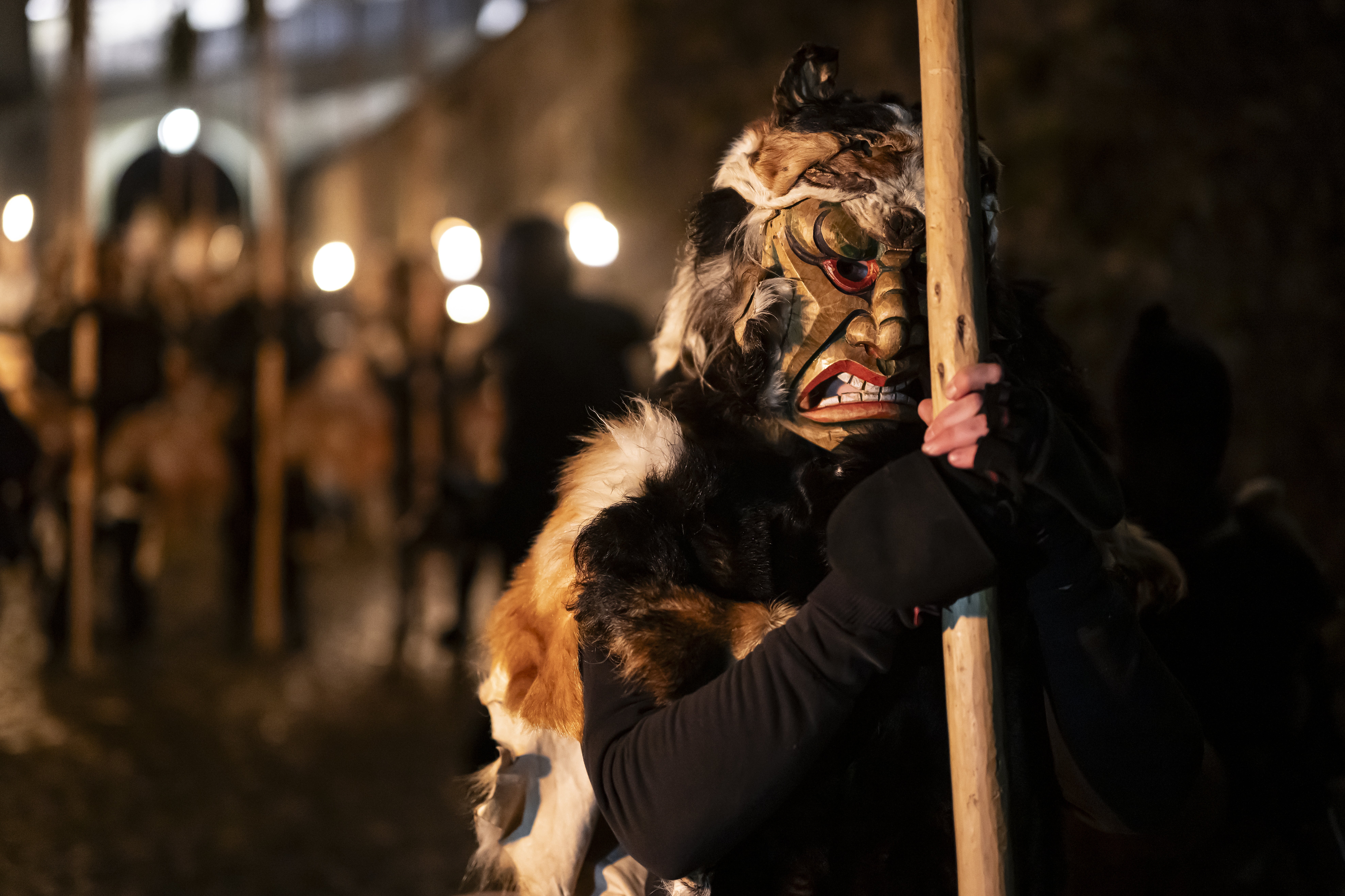 The Anfuehrer equipped with long-handled juniper broom and scary wooden mask, pictured prior the 100th traditional ‘Achetringele’ procession, in Laupen, Switzerland