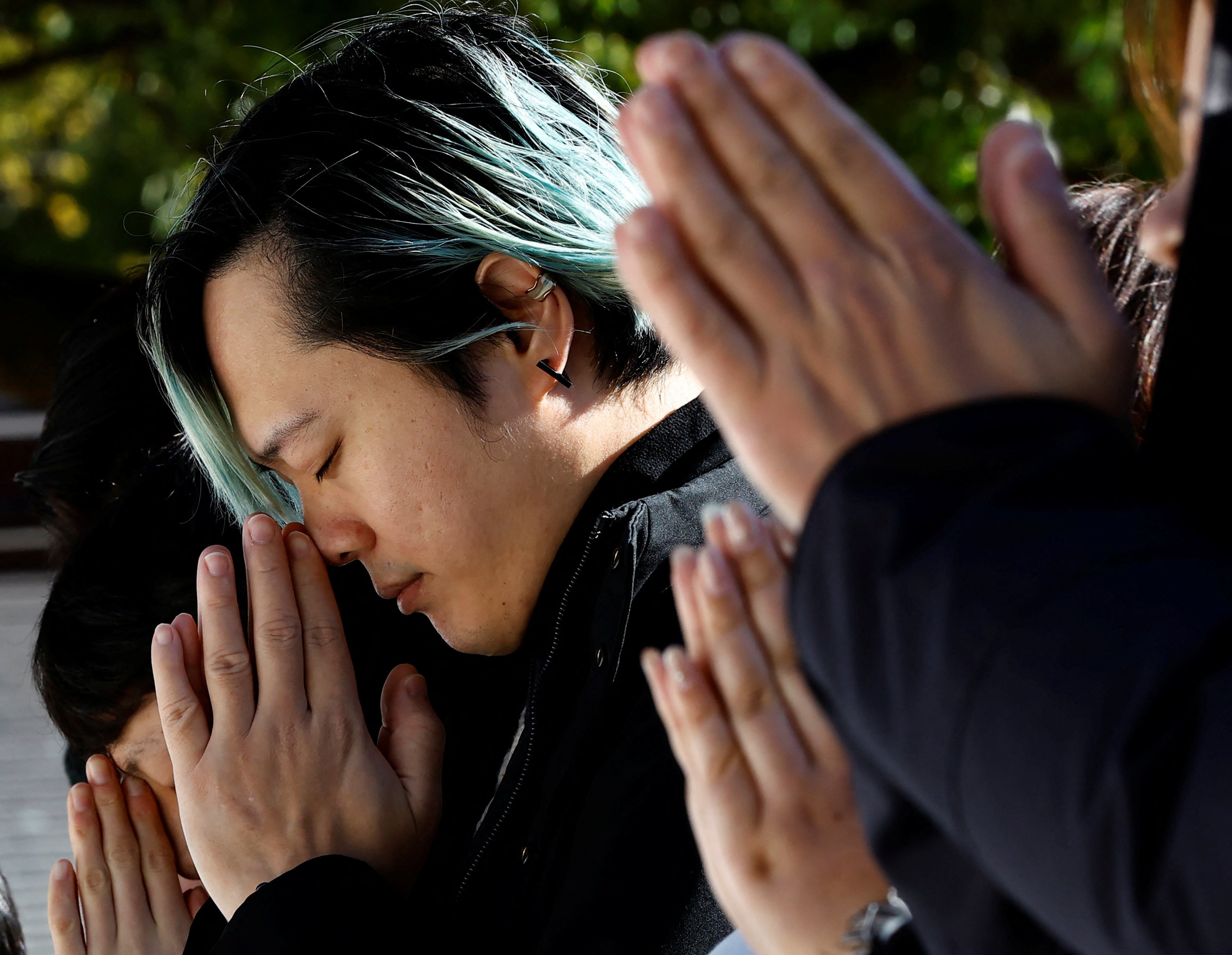 People pray on the first day of the new year at the Meiji Shrine in Tokyo, Japan 1 January 2024