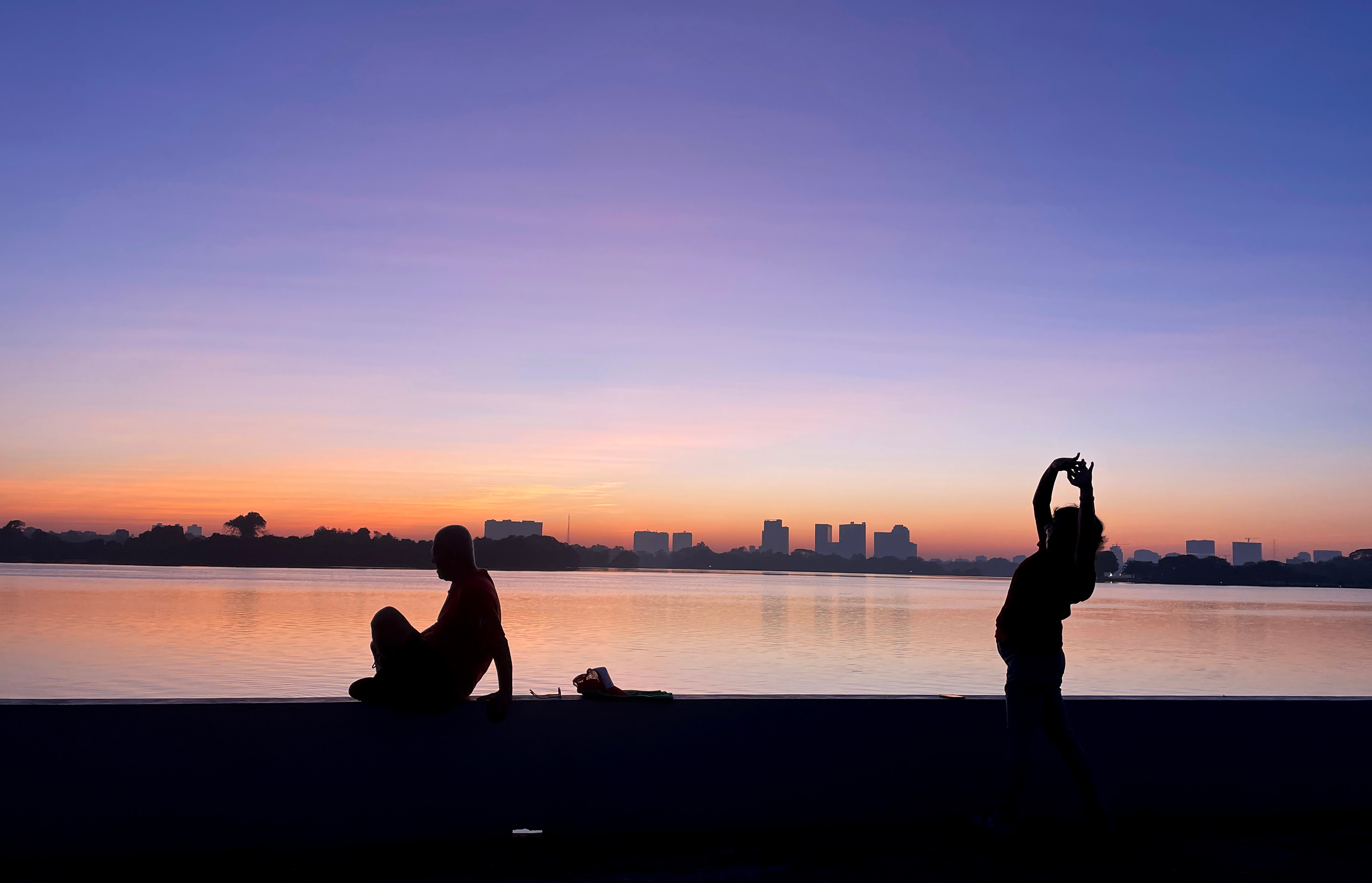 People workout on the bank of Inya lake at dawn on New Years Day in Yangon, Myanmar, 01 January 2024