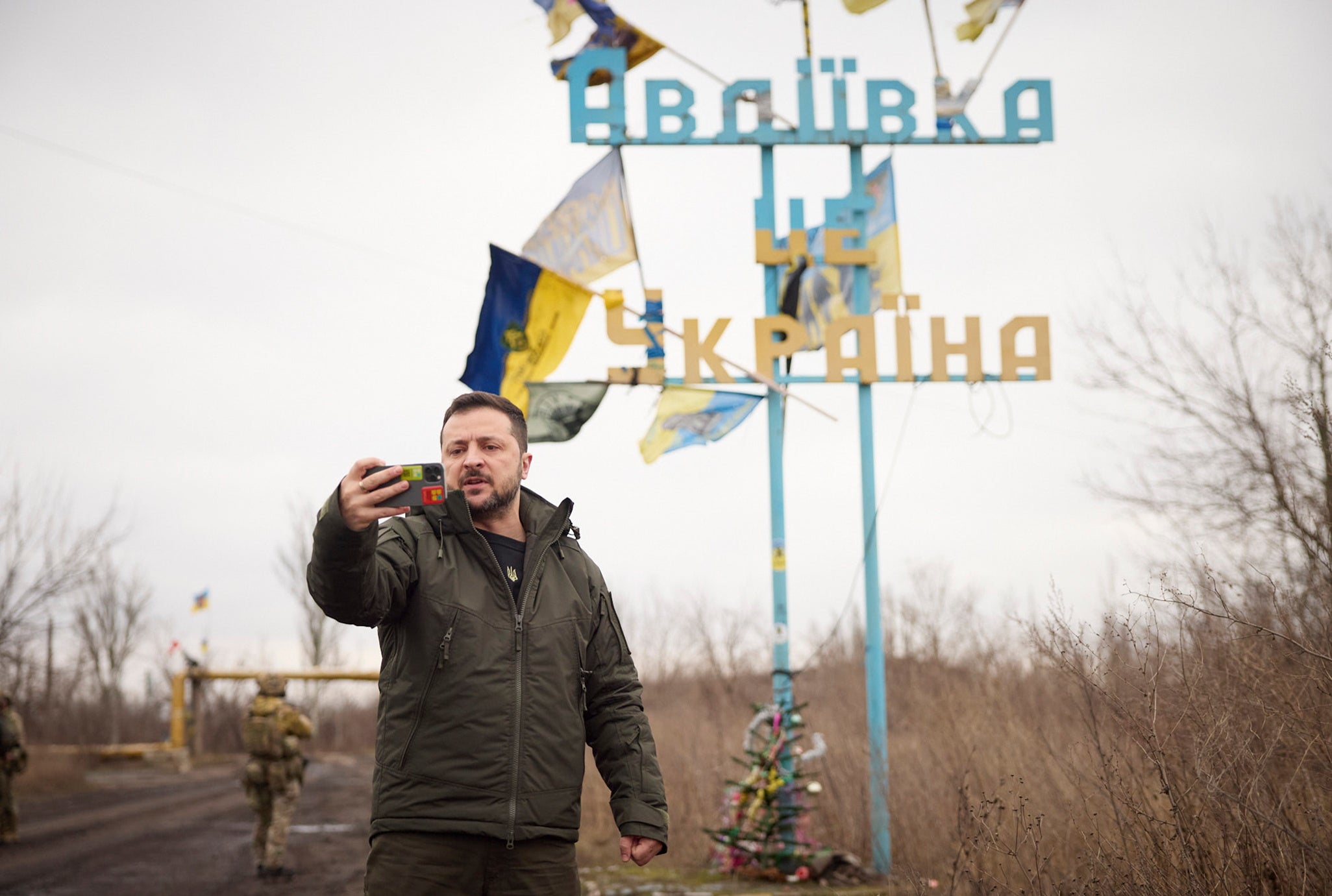 Ukrainian President Volodymyr Zelensky recording his video address in front of the sign 'Avdiivka is Ukraine
