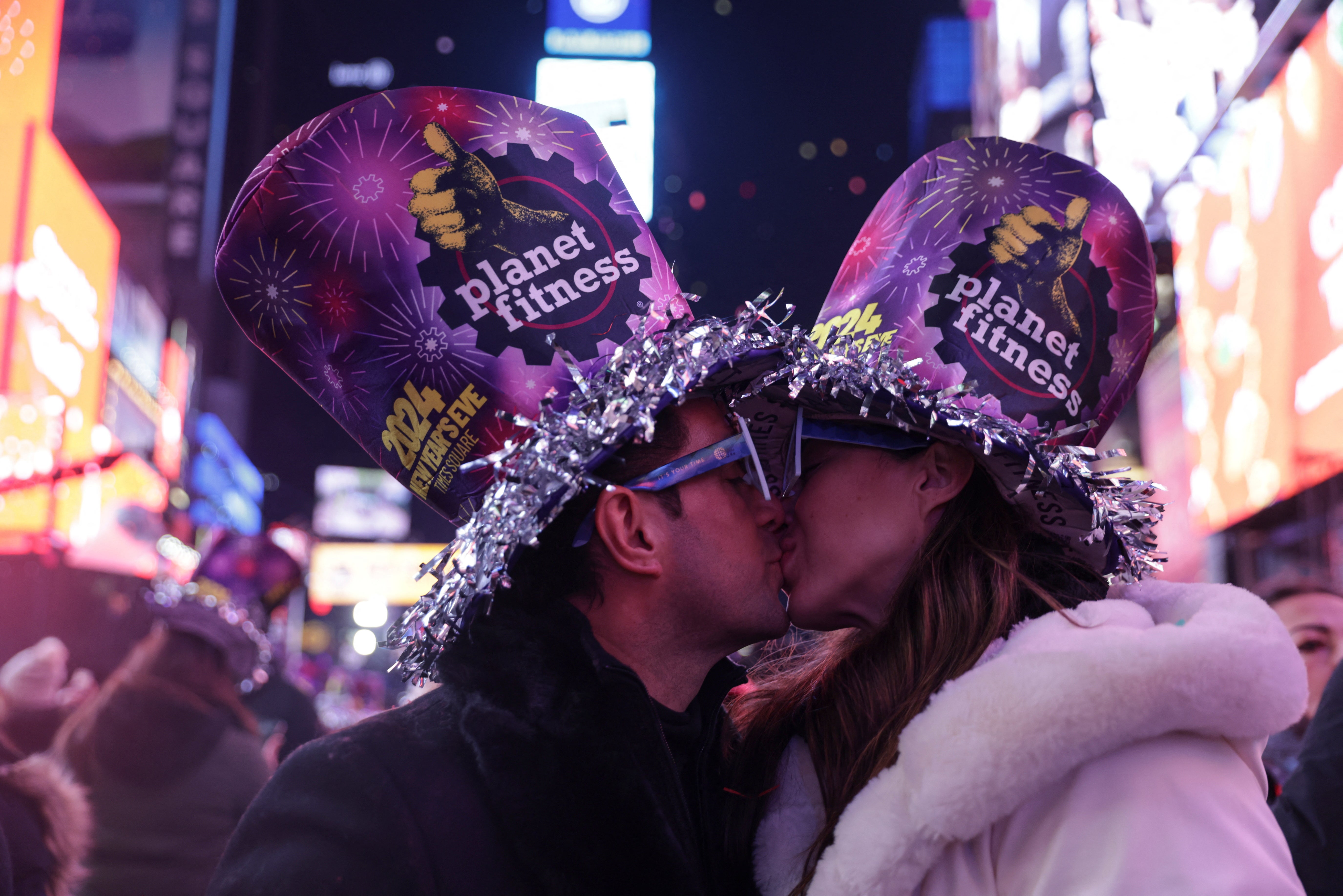 A couple kiss after the clock strikes midnight during New Year celebrations at Times Square, in New York City, New York, US, 1 January 2024