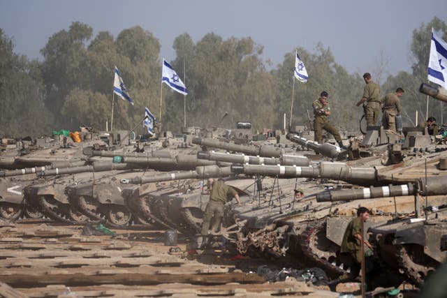 <p>Israeli soldiers and tanks near the Gaza border</p>