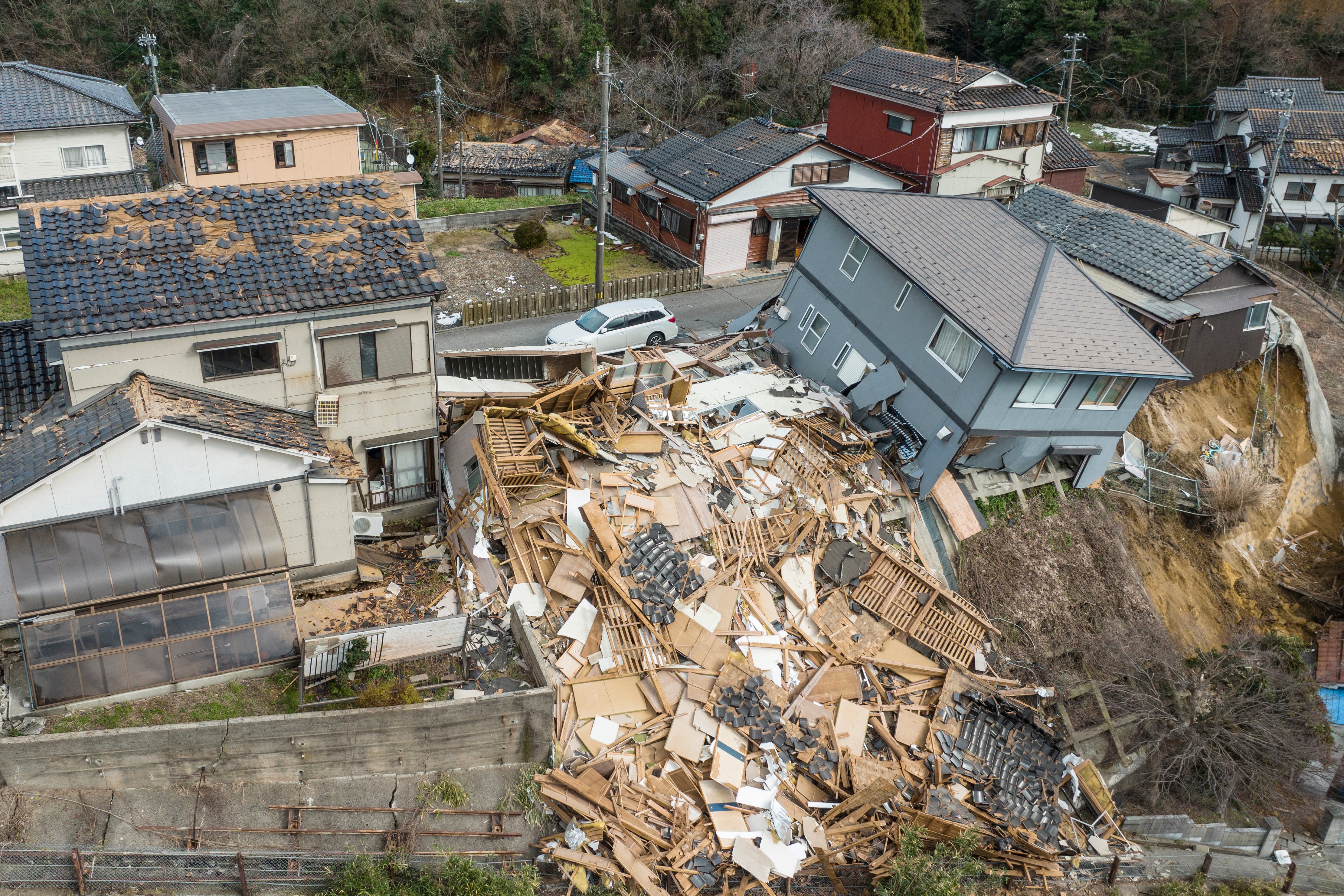 This aerial photo shows damaged and destroyed homes along a street in Wajima, Ishikawa prefecture