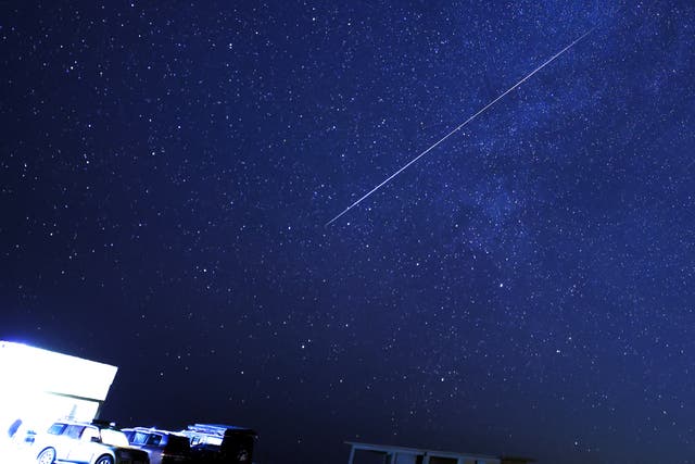 <p>A meteor burns up in the sky over al-Abrak desert north of Kuwait City during the annual Geminid meteor shower early on December 15, 2023</p>
