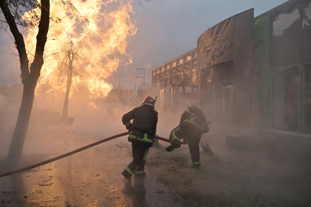 <p>Ukrainian firefighters attempt to extinguish a fire after a missile strike in Kyiv on 2 January </p><p></p>