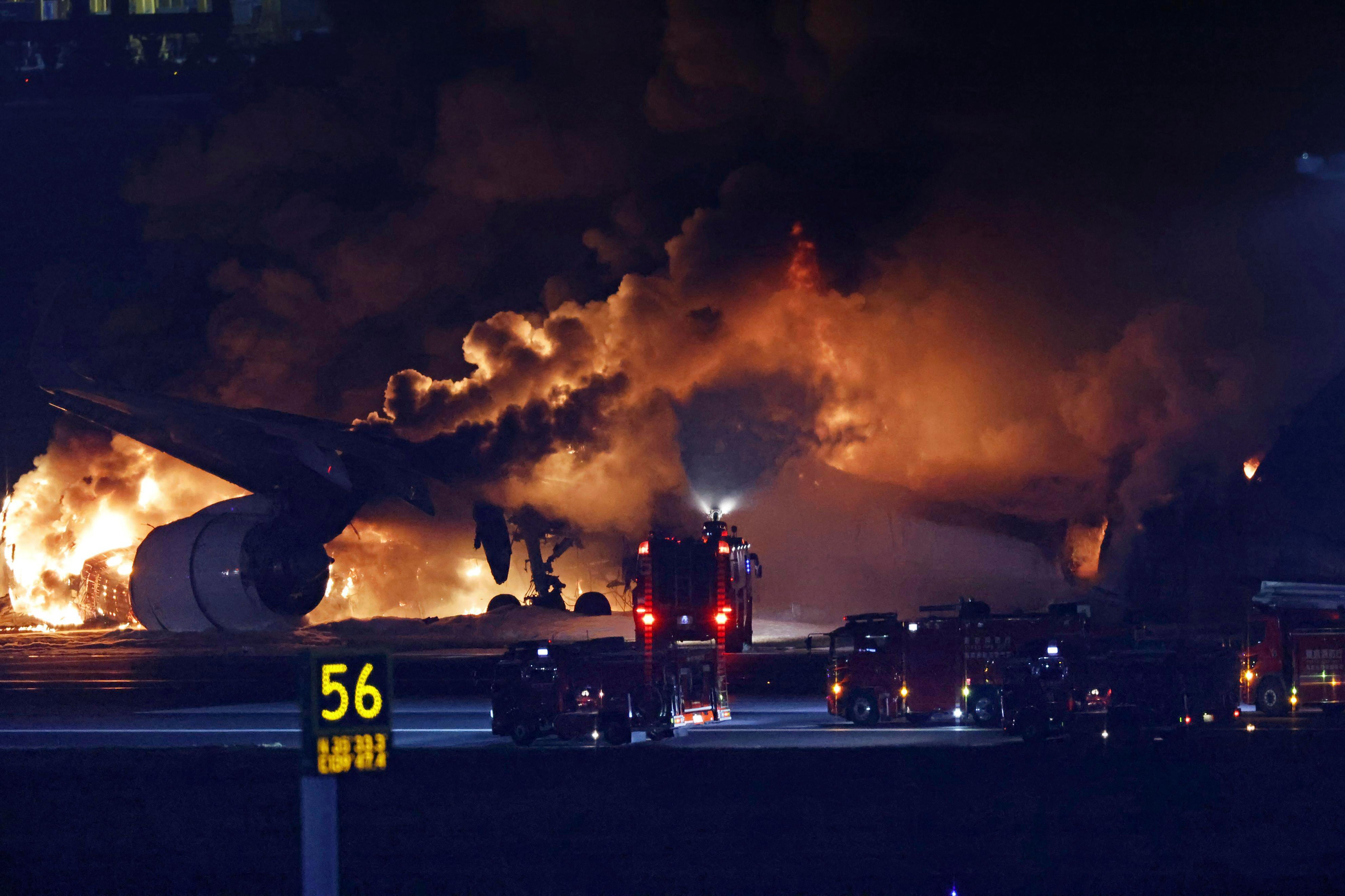 A Japan Airlines plane on fire on the runway of Haneda airport