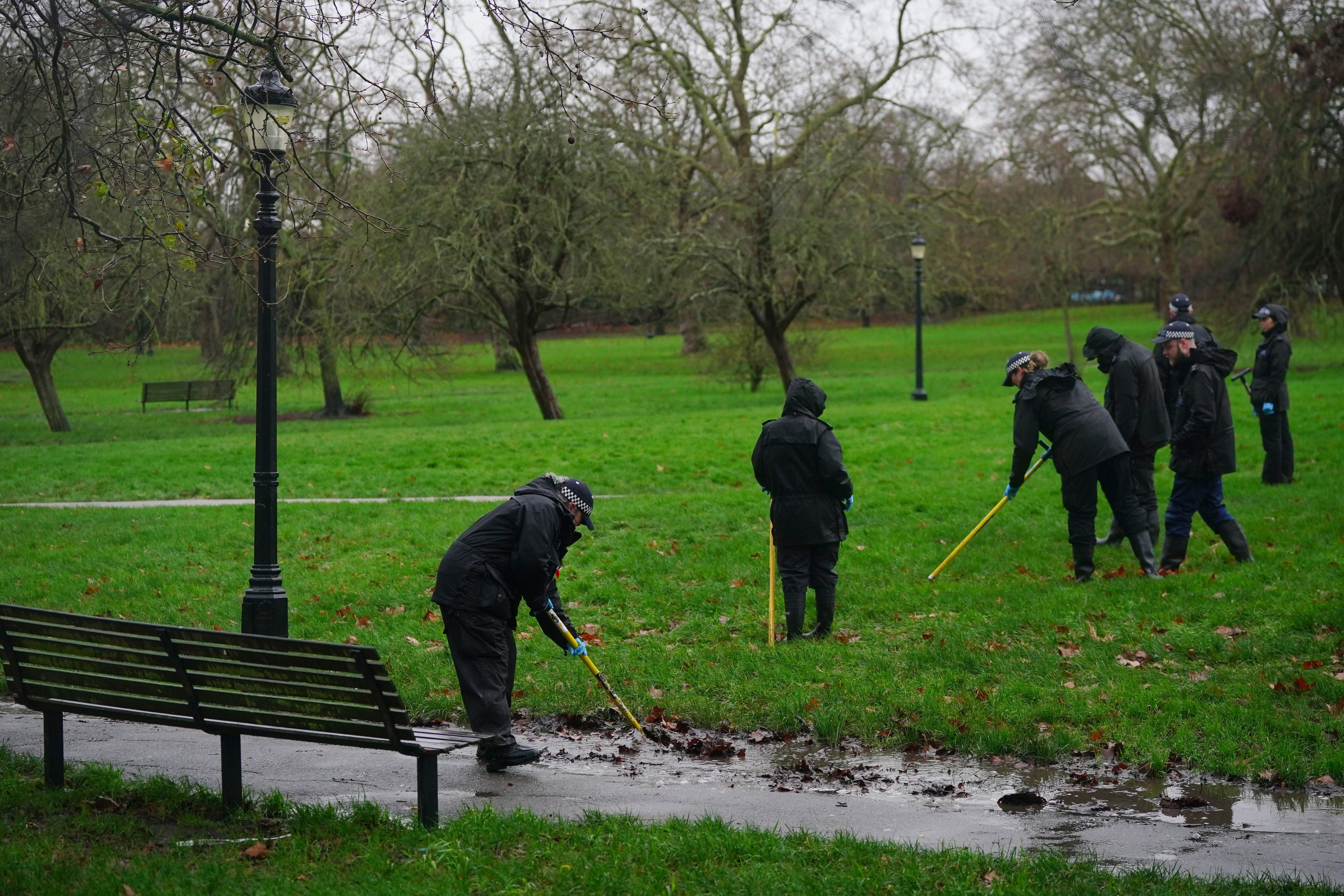 Police officers conduct a search on Primrose Hill in Camden, north London, where 16-year-old Harry Pitman died