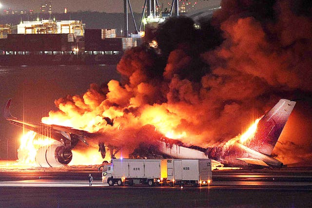 <p>A Japan Airlines plane is engulfed in flames on a runway of Tokyo's Haneda Airport </p>