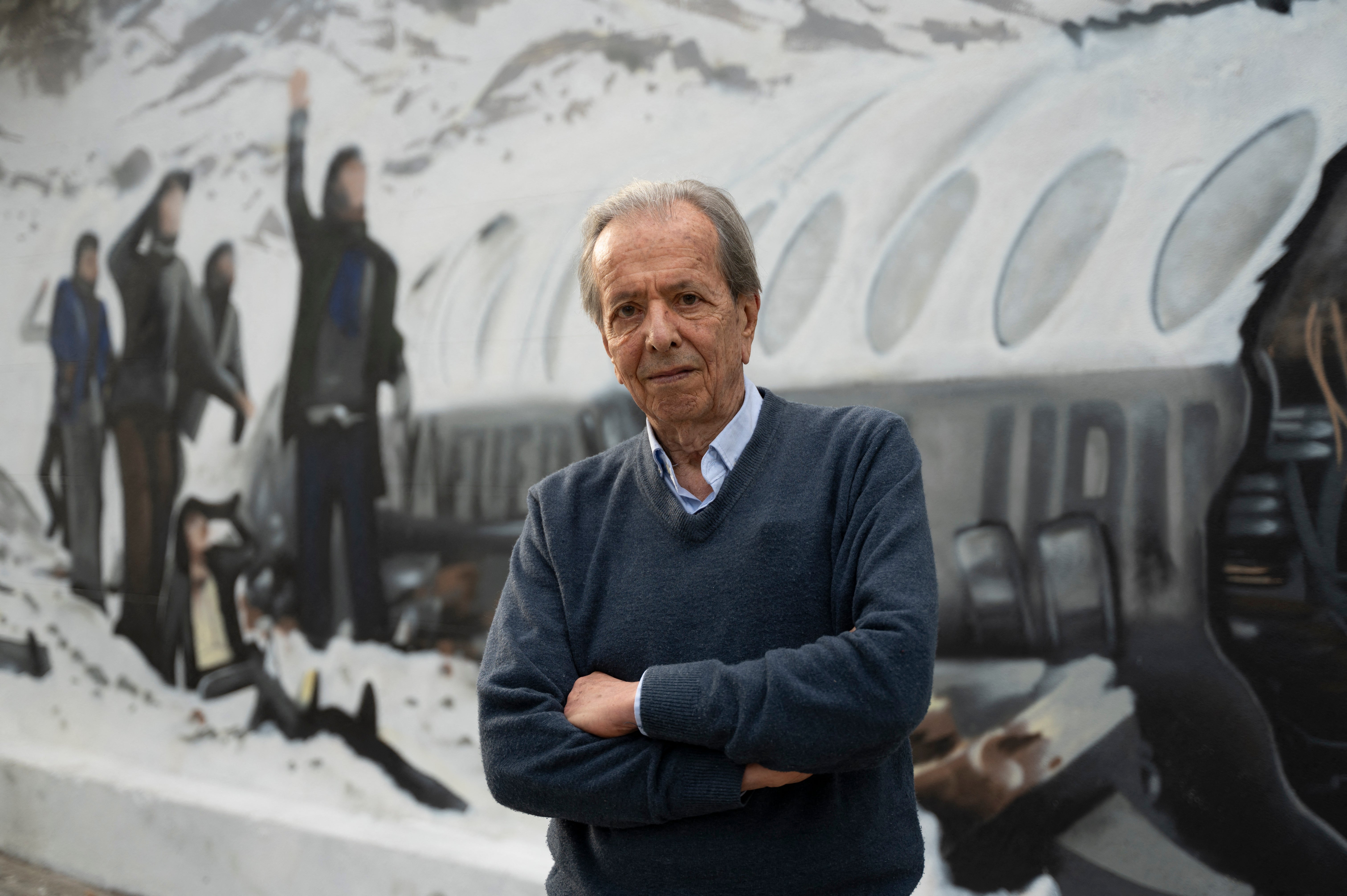pDaniel Fernandez, one of the 16 Uruguayan survivors of the 1972 airplane crash, poses in front of a mural made by Graff Express depicting the accident in Montevideo in November 2023/p