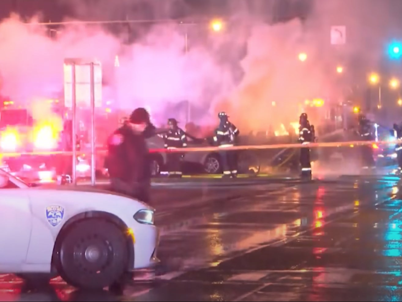 Police and firefighters in Rochester, New York, battle a blaze at the scene of a fiery New Year’s Eve car crash that killed two