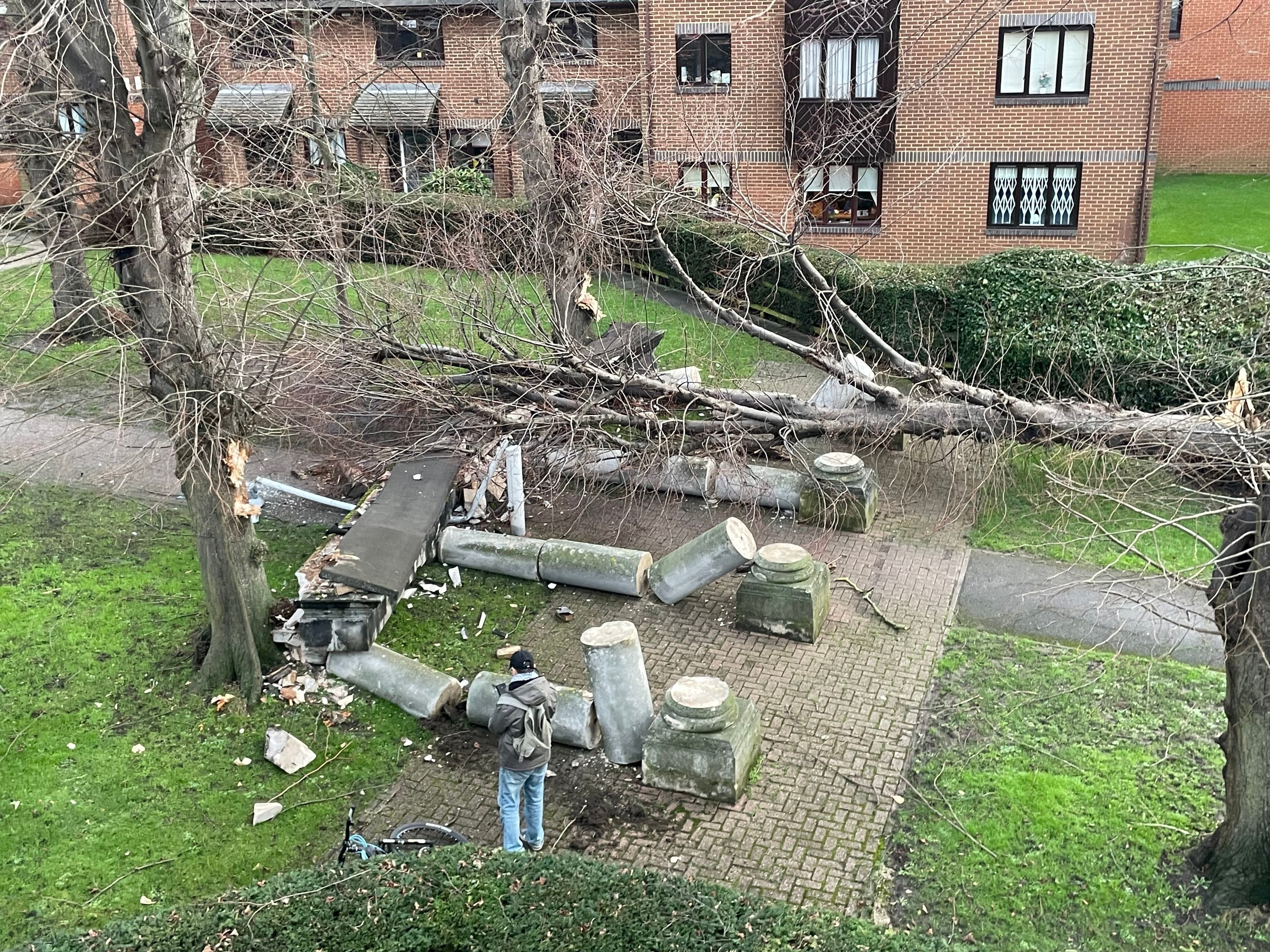 pA tree has been blown over by the wind and crashed into a portico, knocking it down in Tooting, south west London/p