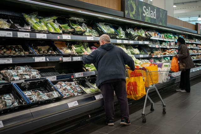Shoppers in the fruit and vegetables section of a branch of Sainsbury’s (PA)