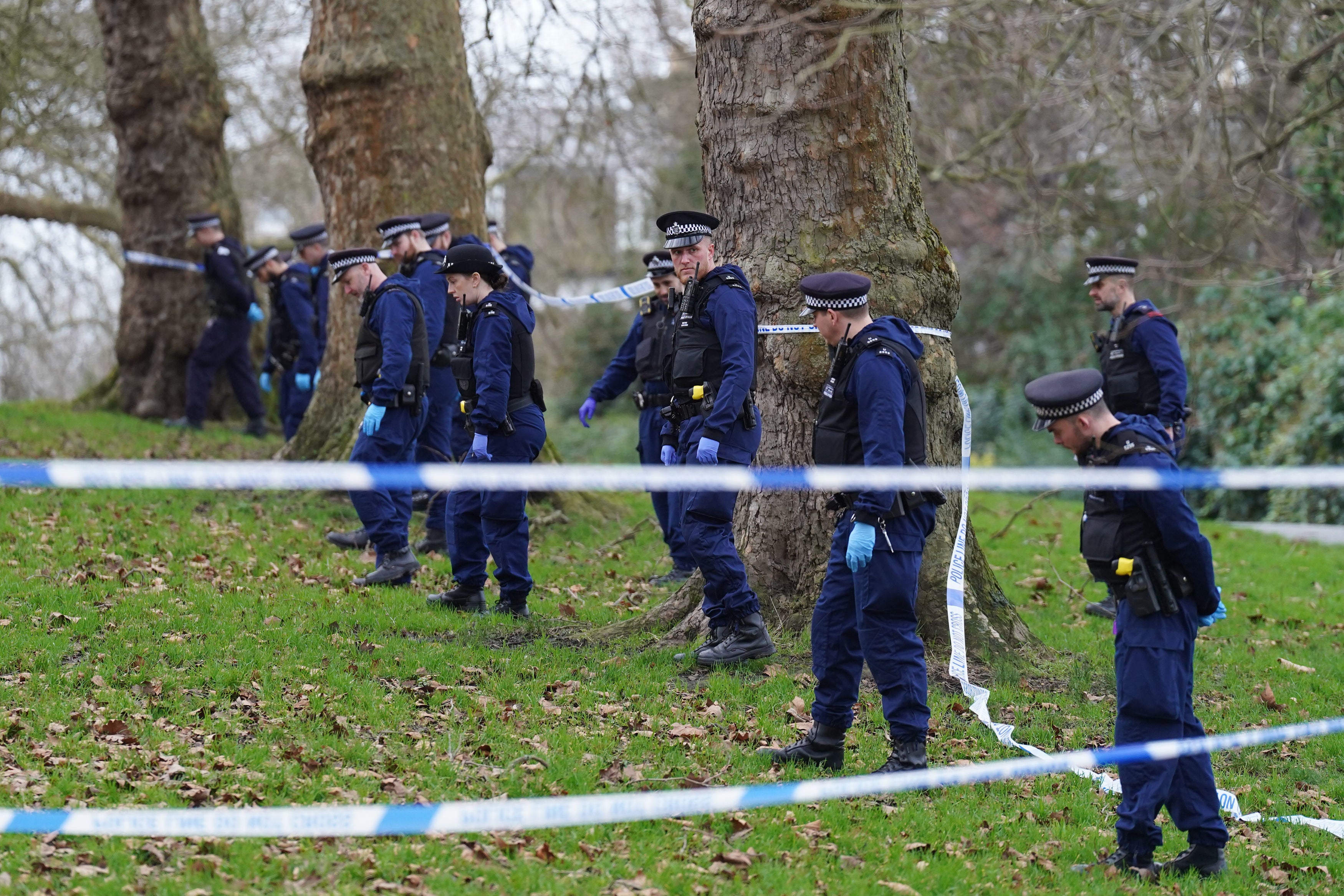 Police officers conduct a fingertip search on Primrose Hill following the tragic incident