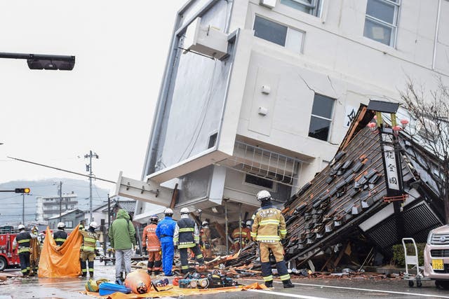 <p>Firefighters work at the scene where a multistorey building toppled over</p>