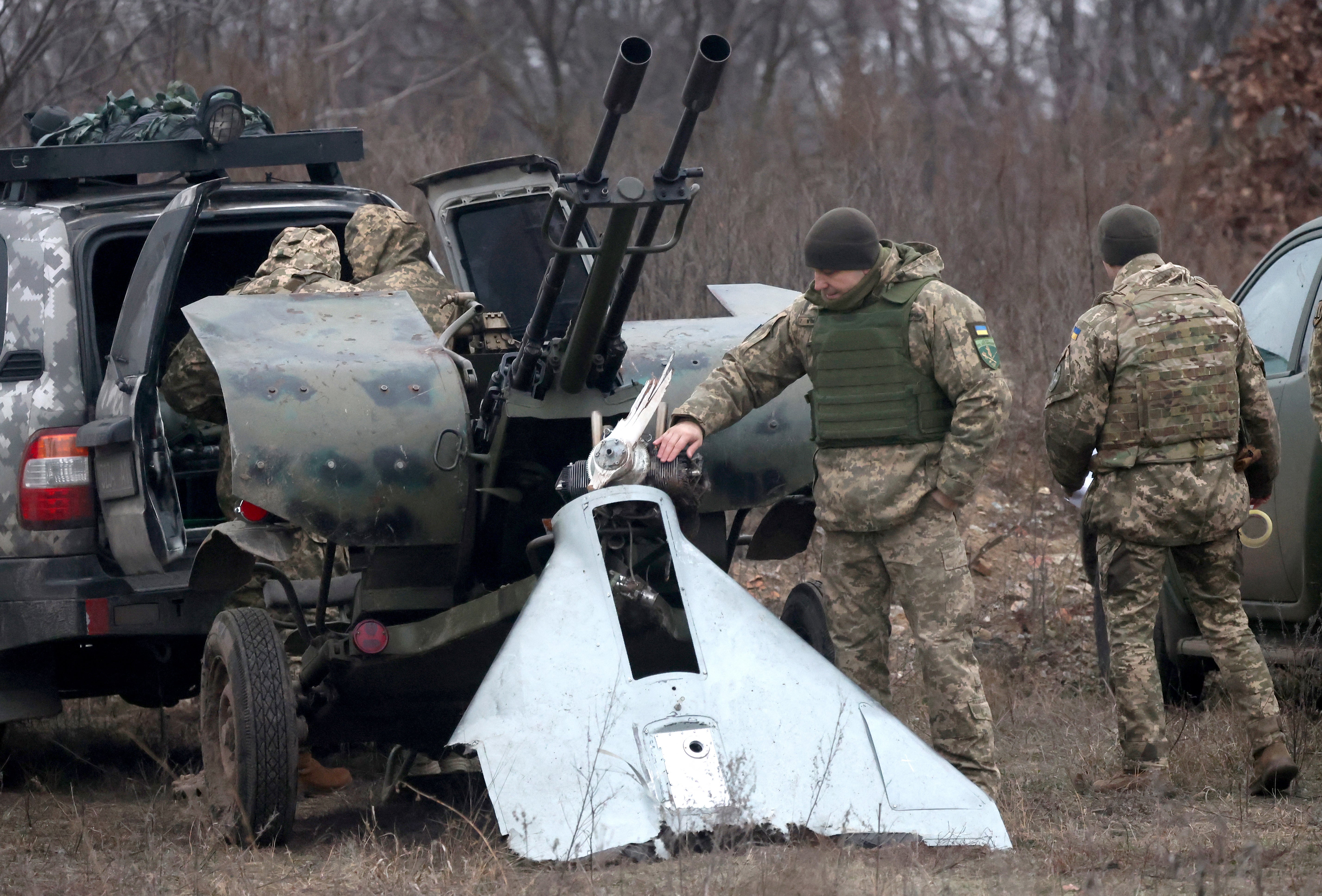 <p>A Ukrainian Air Defence serviceman looks at pieces of a destroyed attacking drone, near Kyiv</p>