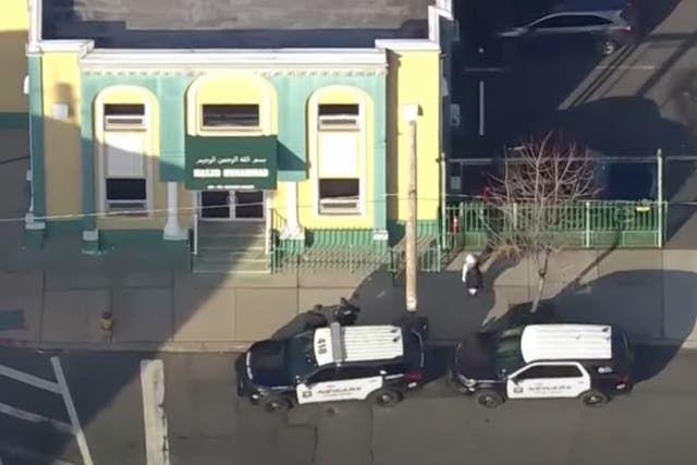 <p>New Jersey police cruisers parked outside a mosque where an imam was shot on Wednesday</p>