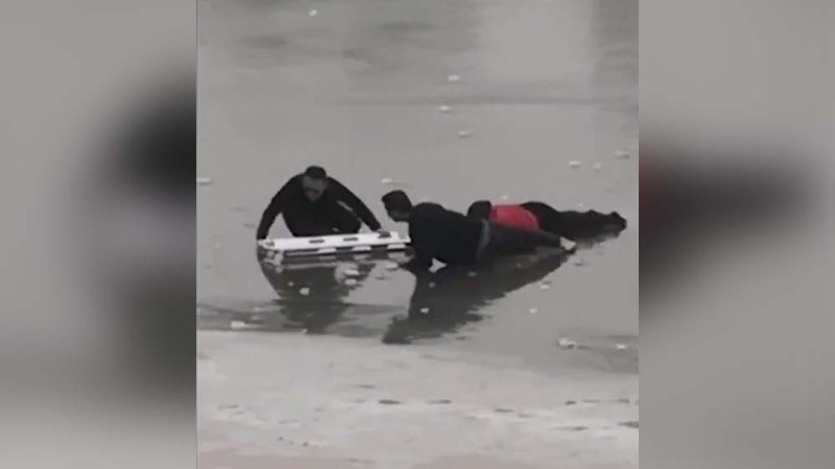 Police officer crawls across frozen lake to save trapped woman in China