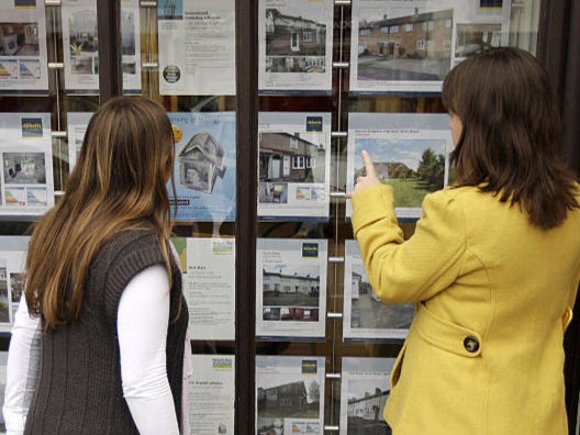 File photo: Two women look at houses for sale